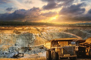 Mining trucks next to a mining pit