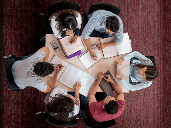 Group of college students studying together in a roundtable